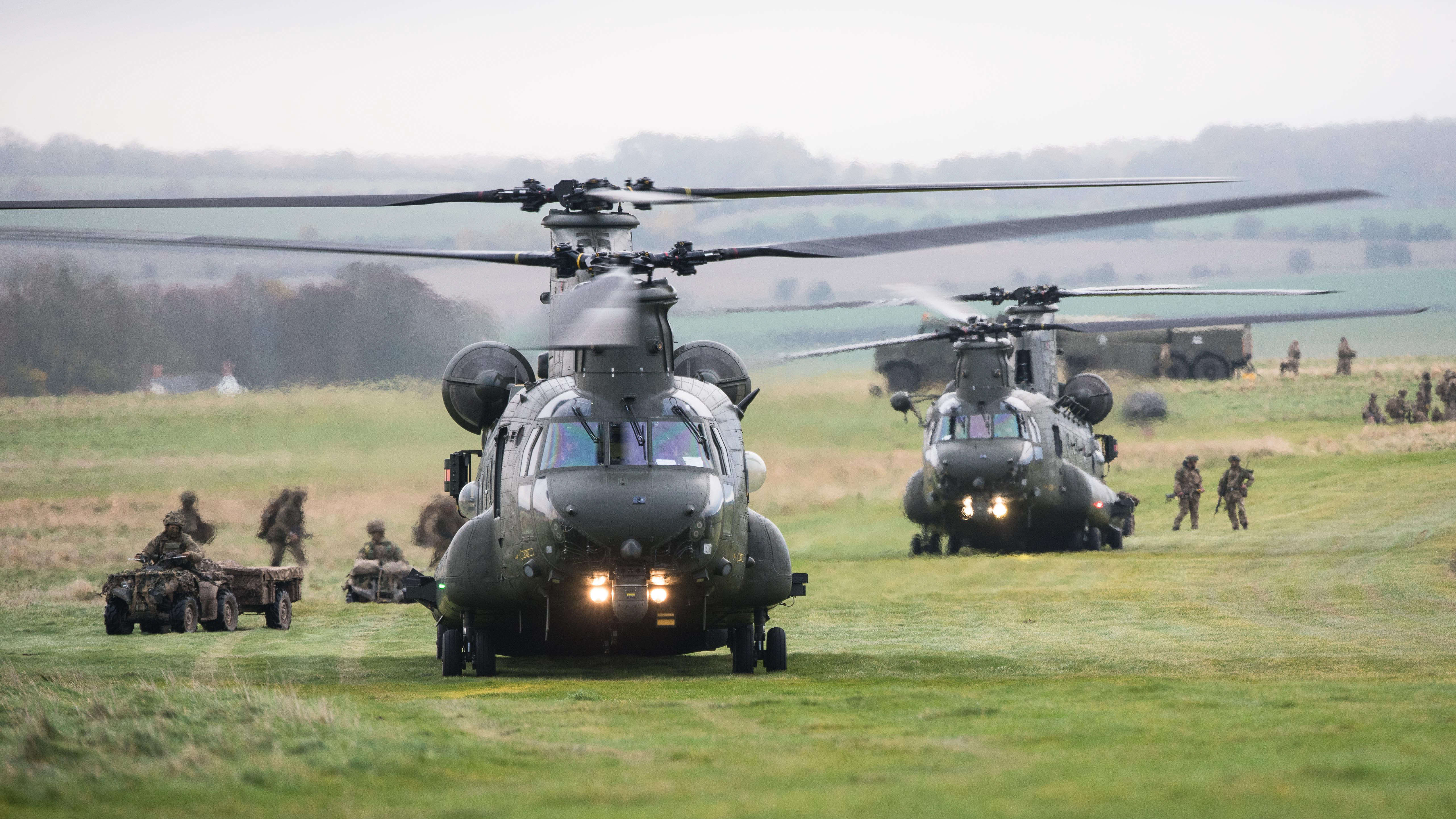 Chinook helicopters are loaded during a military exercise on field